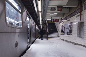 Snow makes it way down to the platform of the 65th Street subway station during a winter storm in New York