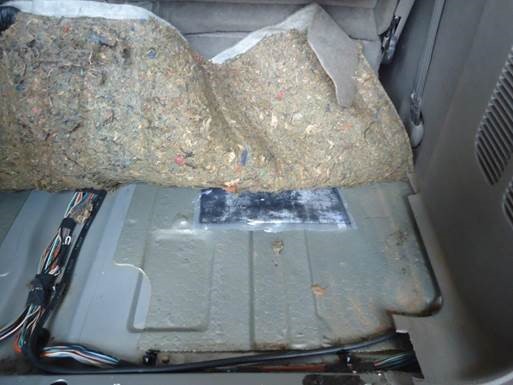 Agents arrested a 63-year-old man after finding almost 30 pounds of methamphetamine hidden under the carpet in the backseat of the minivan he was driving.