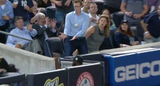 A butter-fingered fan at a Yankees game botches three chances to catch foul ball. (Scroll down for video)