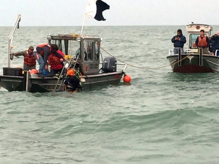 Coast Guard is responding to a report of a discharge of an unknown substance from the site of a barge that sank in 1937 near Kelley's Island Shoal in Lake Erie, Sunday.