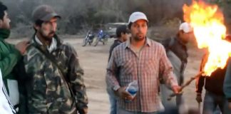 A group of protesters from the indigenous Wichis community in north-west Argentina clashed with riot police officers, setting two of the officers on fire, as they tried to take over the installations of a company, local media reported.