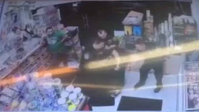 BROOKLYN -- Surveillance video shows a man being assaulted by EMTs while police hold him down. The man is accused of stealing a cell phone from the bodega at 4th Avenue and 56th Street.