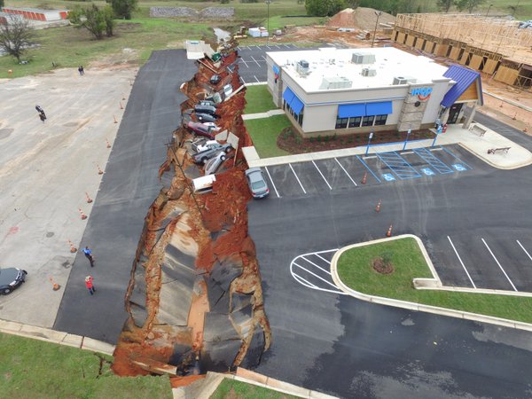 MISSISSIPPI -- (Scroll down for video) -- A huge sinkhole swallowed up over dozen cars in an IHOP parking lot in Mississippi on Saturday, according to local media.